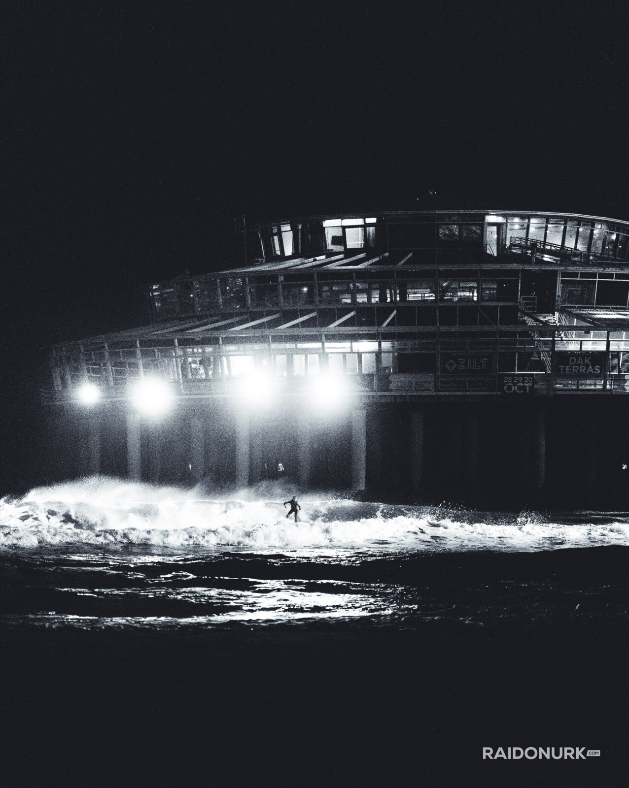 Black and white fine art photographs of surfers in action and at rest, silhouetted against bright skies and dramatic waves, capturing the essence of surfing in a minimalist, high-contrast visual style.