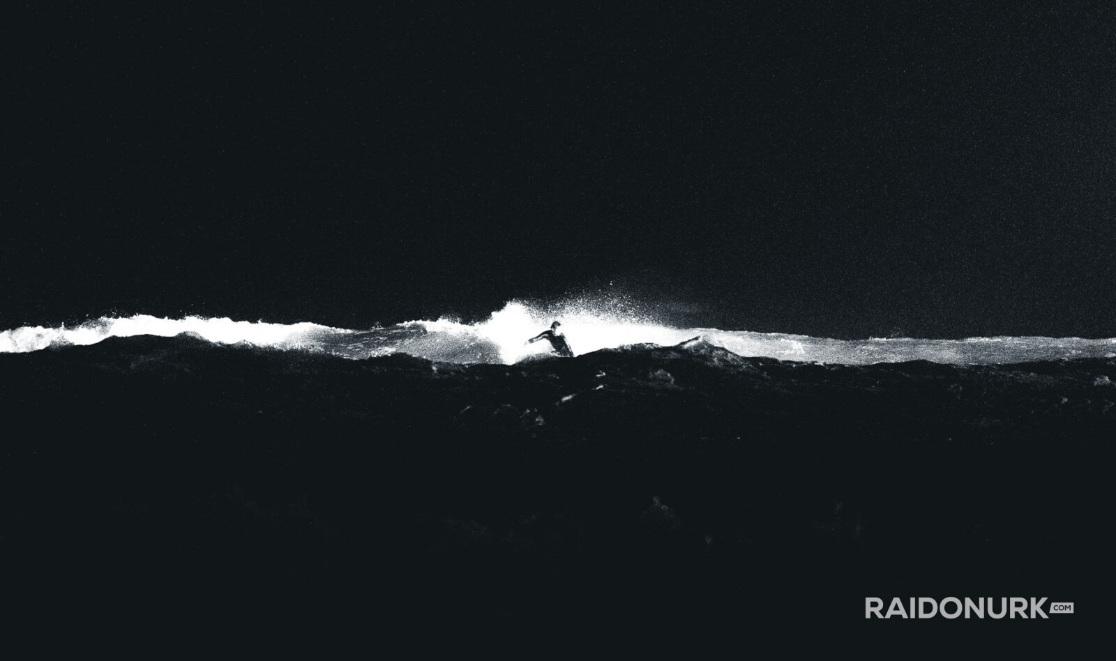 Black and white fine art photographs of surfers in action and at rest, silhouetted against bright skies and dramatic waves, capturing the essence of surfing in a minimalist, high-contrast visual style.