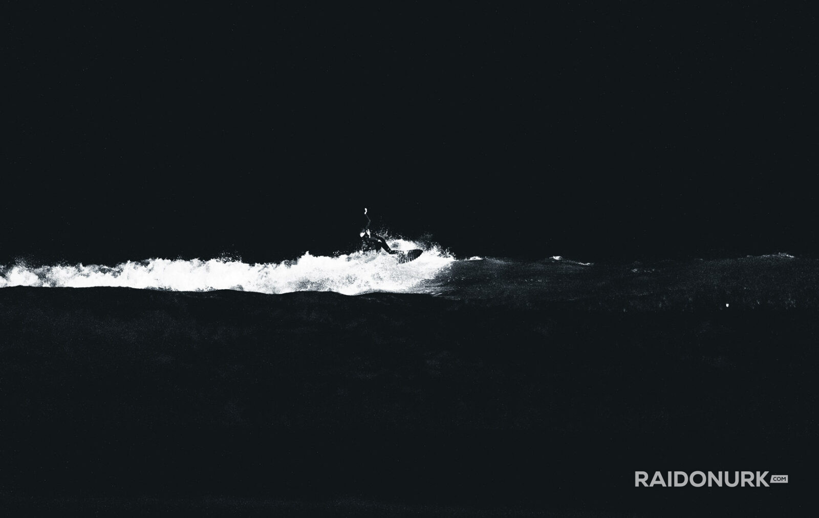 Black and white fine art photographs of surfers in action and at rest, silhouetted against bright skies and dramatic waves, capturing the essence of surfing in a minimalist, high-contrast visual style.